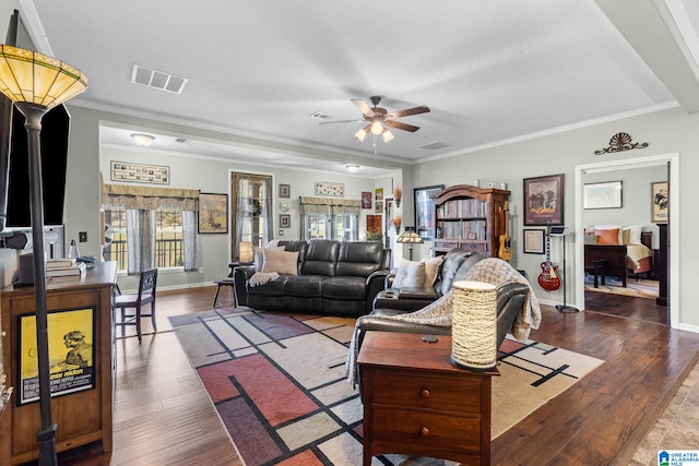 living room with ornamental molding, ceiling fan, and dark hardwood / wood-style floors