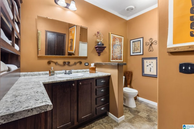 bathroom featuring toilet, ornamental molding, and vanity