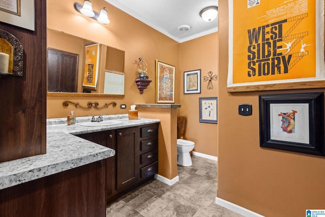 bathroom with crown molding, vanity, and toilet