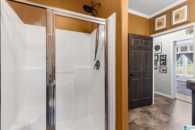 bathroom with crown molding and a shower with shower door