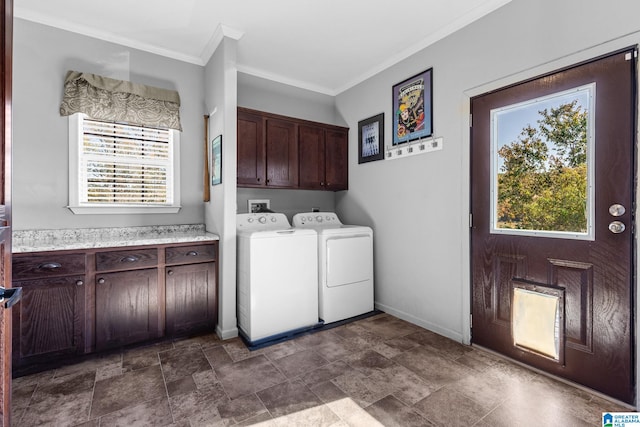 laundry area featuring ornamental molding, cabinets, and independent washer and dryer