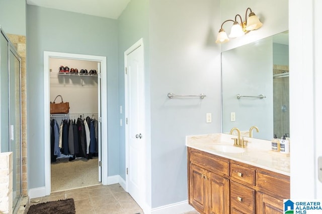 bathroom featuring vanity, tile patterned flooring, and an enclosed shower