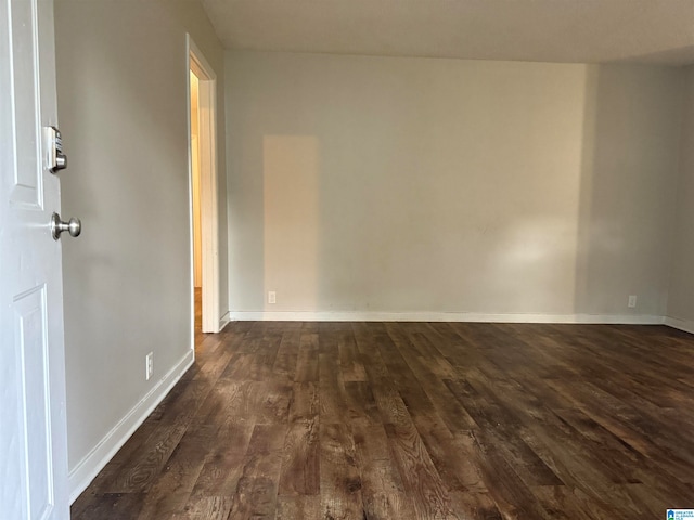 spare room featuring dark hardwood / wood-style floors