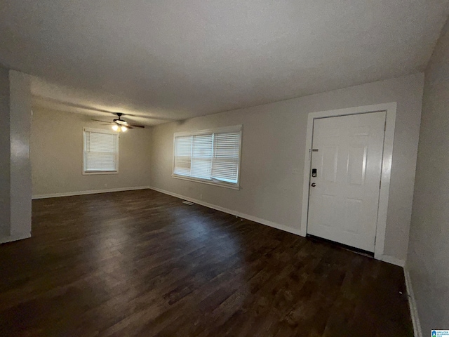 entryway with dark hardwood / wood-style flooring and ceiling fan