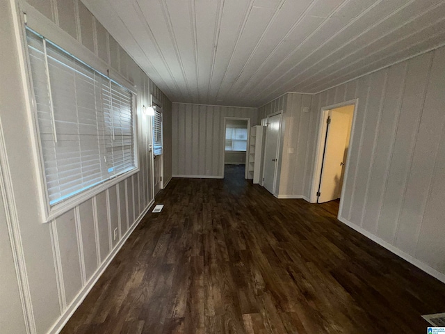 hall with wood walls and dark hardwood / wood-style floors