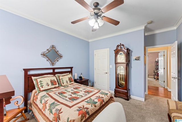 carpeted bedroom with ceiling fan and crown molding