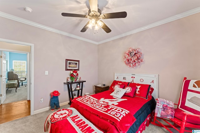 carpeted bedroom featuring ornamental molding and ceiling fan