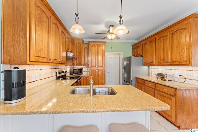 kitchen with stainless steel appliances, sink, kitchen peninsula, a kitchen breakfast bar, and light stone countertops