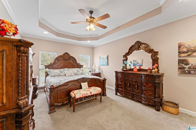 bedroom with a raised ceiling, light carpet, ceiling fan, and crown molding