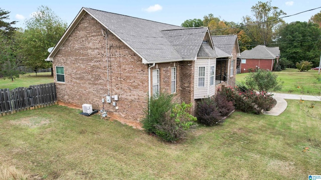 view of side of property with a lawn