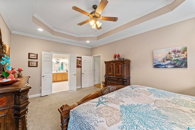 bedroom featuring ceiling fan, connected bathroom, light carpet, and crown molding