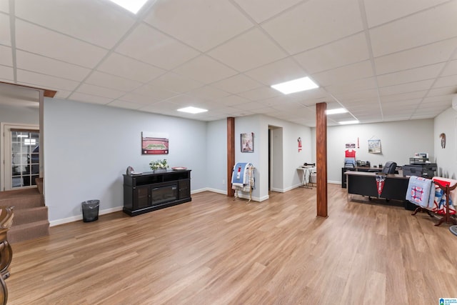 interior space with a paneled ceiling and light wood-type flooring