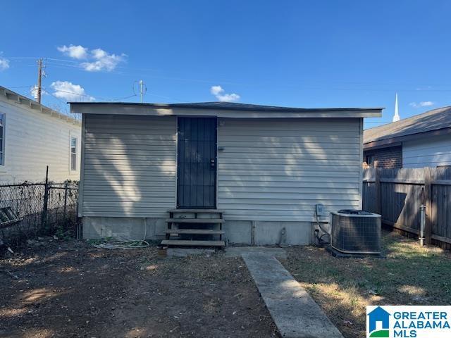 109 2nd Ave SW, Birmingham, AL 35211 - back of property featuring central air condition unit, fence, and entry steps