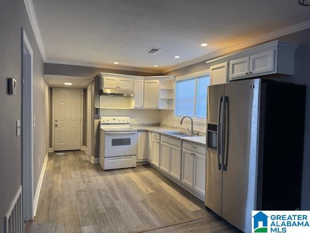 109 2nd Ave SW, Birmingham, AL 35211 - kitchen with stainless steel fridge, a sink, white electric stove, and ornamental molding