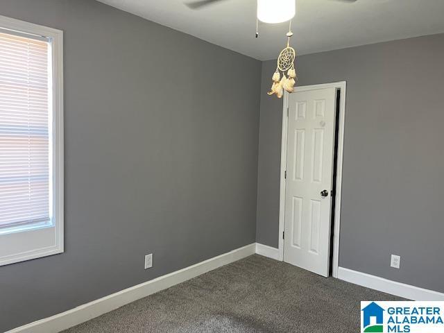 109 2nd Ave SW, Birmingham, AL 35211 - empty room with baseboards, ceiling fan, and dark carpet