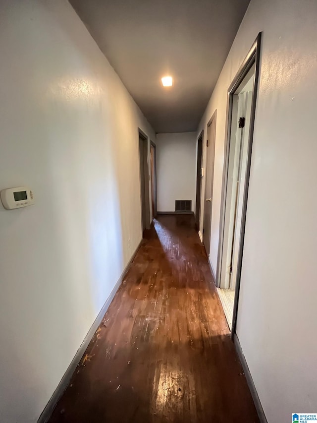 hallway with dark hardwood / wood-style flooring