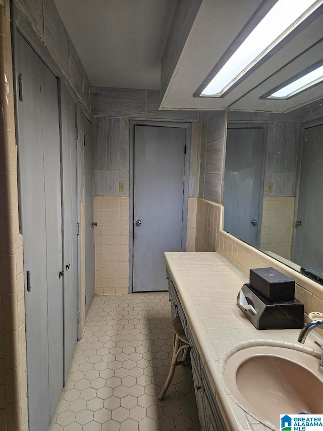 bathroom featuring vanity, tile walls, and tile patterned flooring