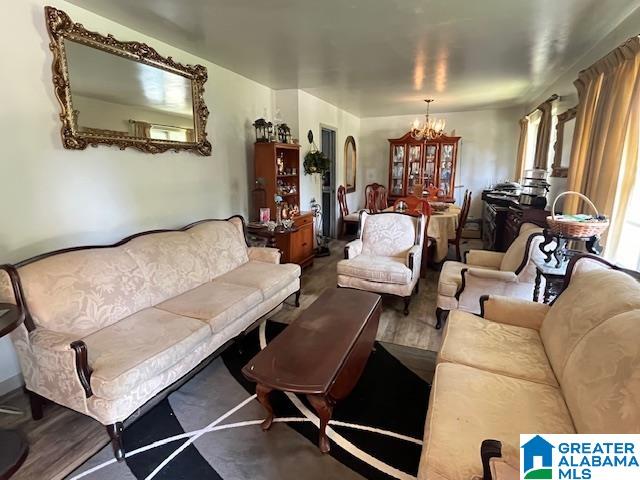 living room featuring hardwood / wood-style flooring and a chandelier