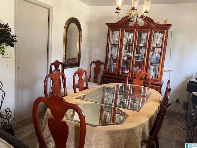 dining room with a chandelier and hardwood / wood-style flooring