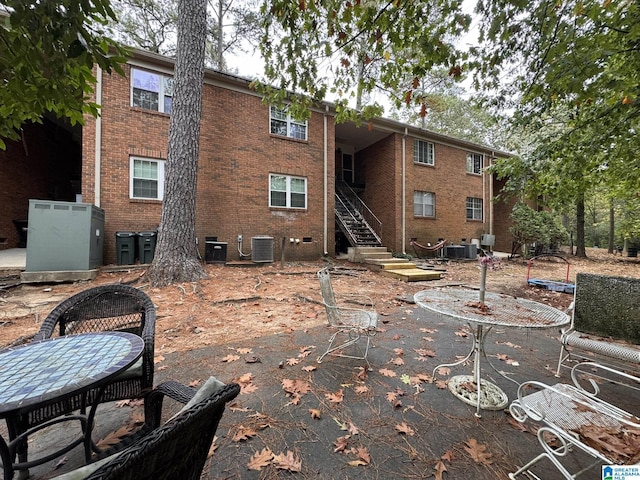 2082 Montreat Cir Unit 2082, Vestavia Hills, AL 35216 - rear view of property featuring central AC unit, stairway, and brick siding