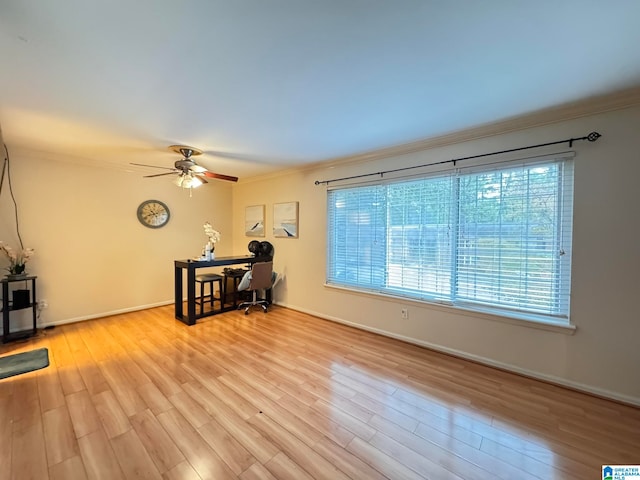 living room with light hardwood / wood-style flooring, ceiling fan, and crown molding