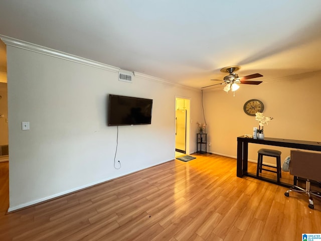 unfurnished living room with light hardwood / wood-style floors, ceiling fan, and crown molding