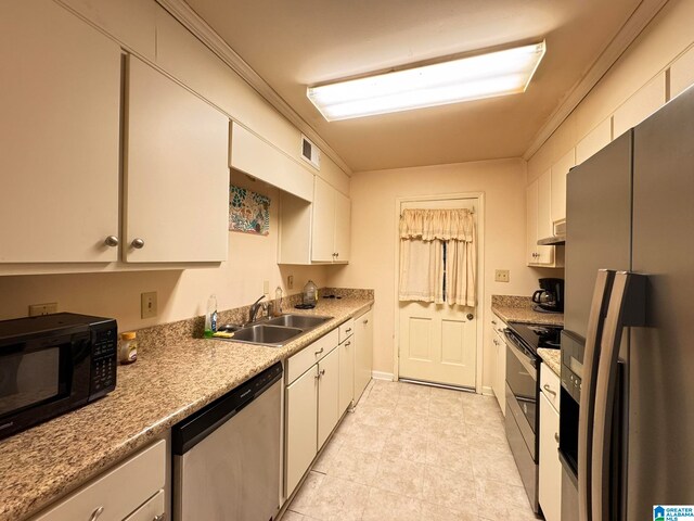 kitchen with white cabinetry, appliances with stainless steel finishes, sink, and crown molding