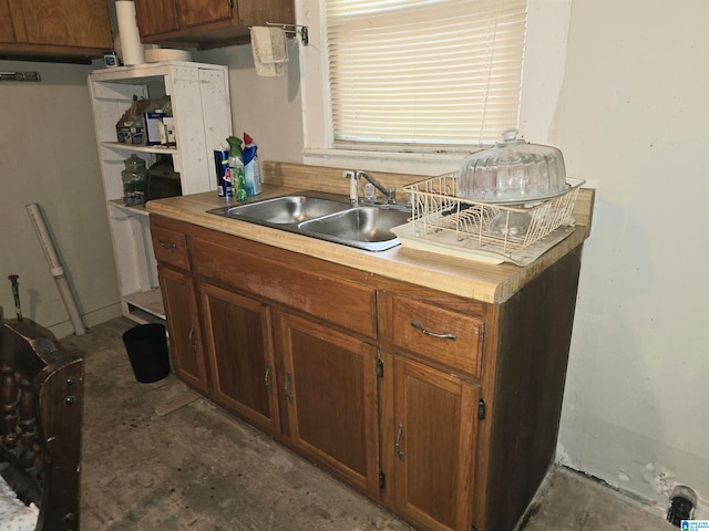 kitchen featuring concrete floors and sink