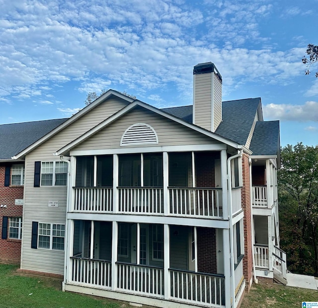 back of house featuring a balcony