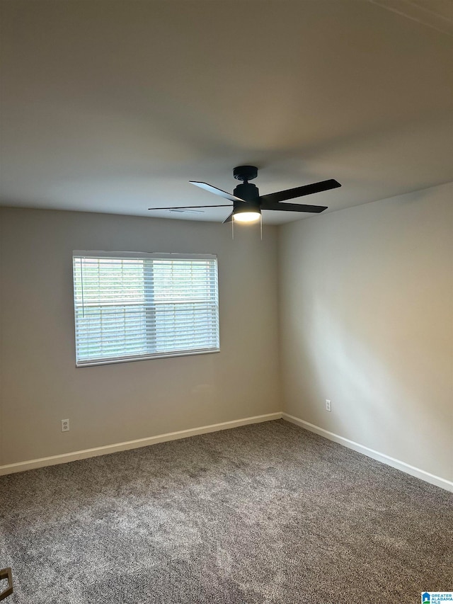 carpeted spare room featuring ceiling fan