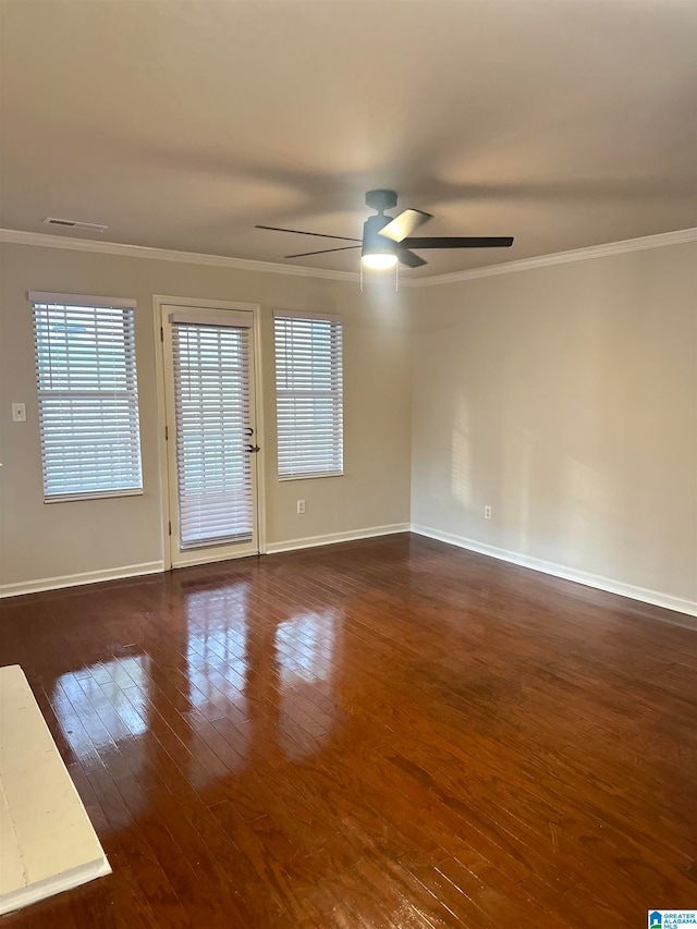 spare room featuring ornamental molding, dark wood-type flooring, and ceiling fan