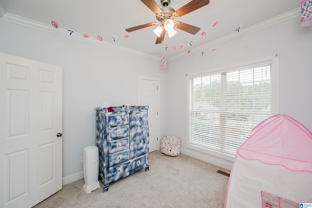 carpeted bedroom featuring ceiling fan and ornamental molding