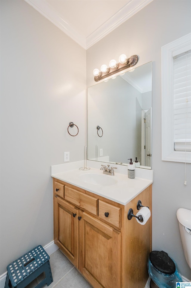 bathroom featuring tile patterned flooring, vanity, toilet, and crown molding