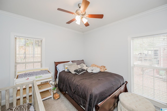 bedroom with ceiling fan, crown molding, and multiple windows