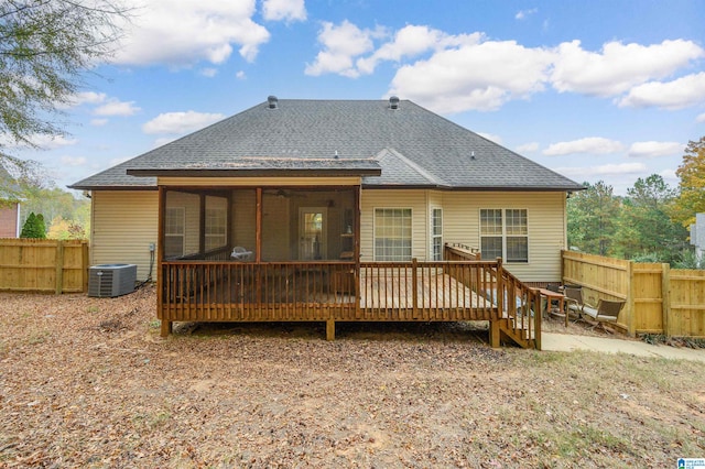 back of house with a sunroom, a wooden deck, and central AC