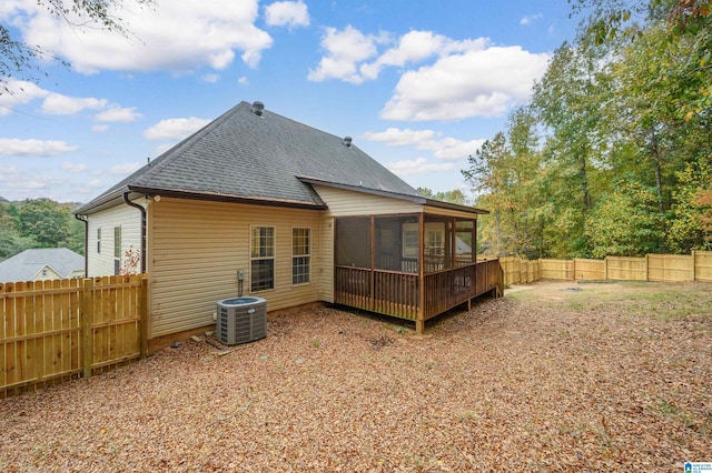 rear view of house with a sunroom and cooling unit