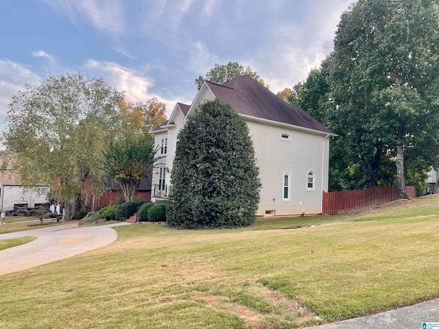 view of home's exterior with a yard