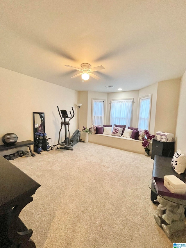 workout area featuring carpet and ceiling fan