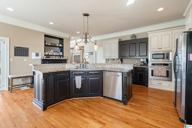 kitchen featuring light hardwood / wood-style floors, stainless steel appliances, and a kitchen island with sink