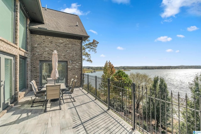 balcony with a water view and a patio