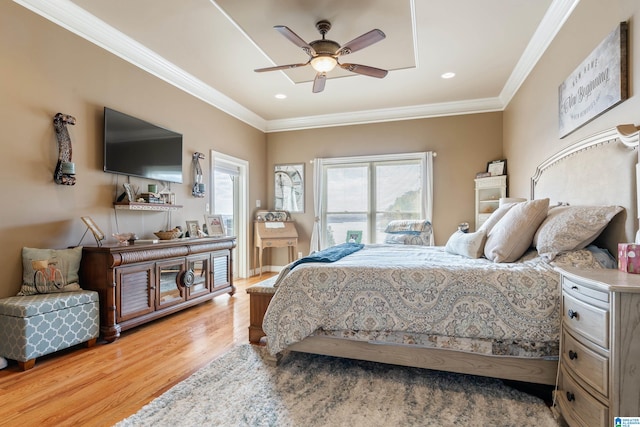 bedroom with light hardwood / wood-style flooring, ornamental molding, and ceiling fan