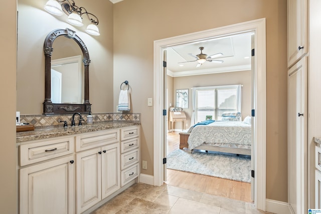 bathroom featuring vanity, crown molding, wood-type flooring, and ceiling fan