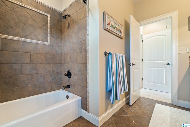 bathroom with tiled shower / bath and tile patterned floors