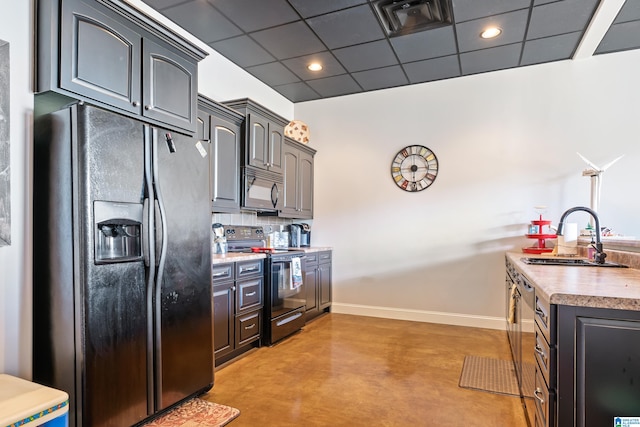 kitchen with backsplash, black appliances, sink, and a drop ceiling