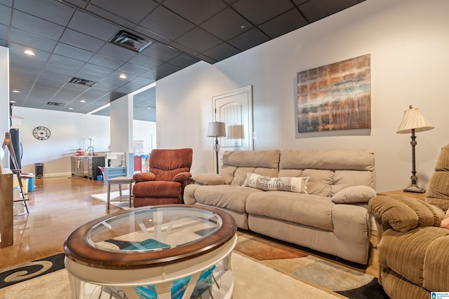 living room featuring sink and a drop ceiling