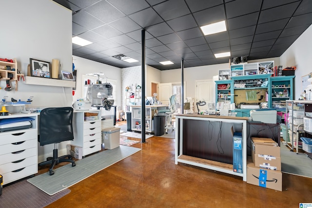 office space featuring concrete flooring and a paneled ceiling