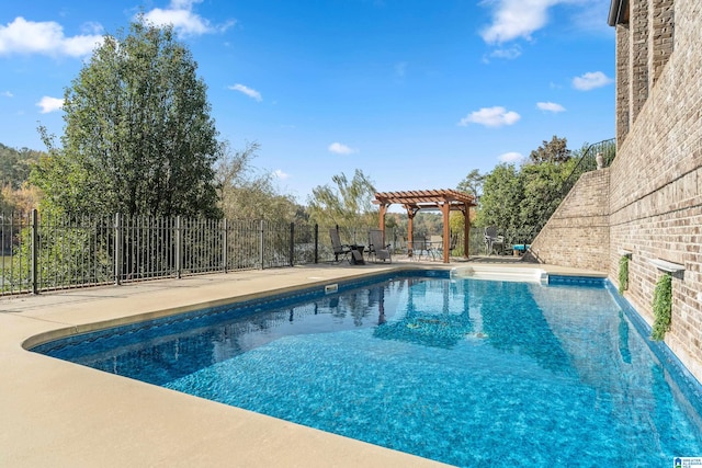 view of swimming pool with a patio and a pergola