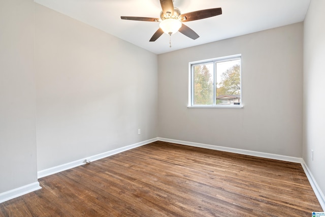 unfurnished room with ceiling fan and dark hardwood / wood-style flooring