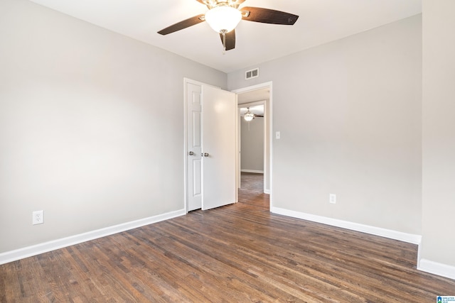 empty room with dark hardwood / wood-style floors and ceiling fan