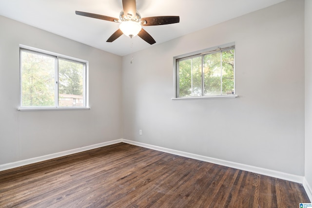 unfurnished room with dark wood-type flooring, a healthy amount of sunlight, and ceiling fan